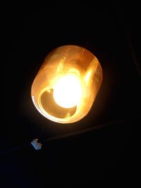 Low angle view of lit light bulb