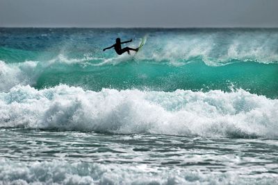 Person surfing in sea