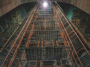 Low angle view of illuminated bridge in building