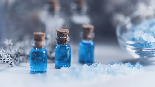 Close-up of liquid in bottles on table at spa