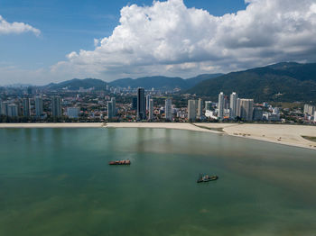 Scenic view of sea and buildings against sky