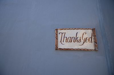 Low angle view of thanks god sign on wall