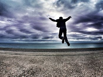 Woman jumping over water