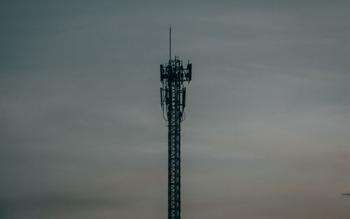 Low angle view of communications tower against sky