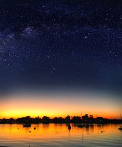 Scenic view of lake against sky at night