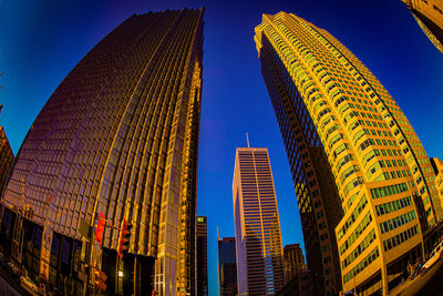 Low angle view of skyscrapers against sky at night