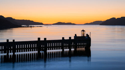 Silhouette pier on sea against sky during sunset