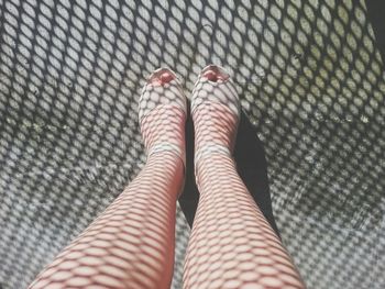 Low section of woman standing on tiled floor