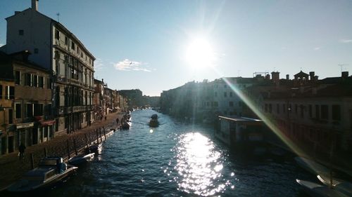 Canal amidst buildings against sky