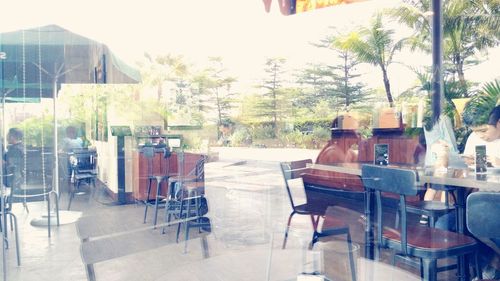 Empty chairs and tables at sidewalk cafe