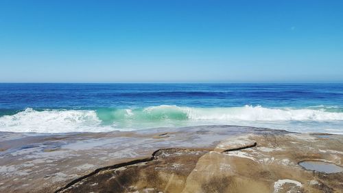 Scenic view of sea against clear blue sky