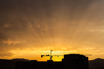 Low angle view of silhouette buildings against sky during sunset