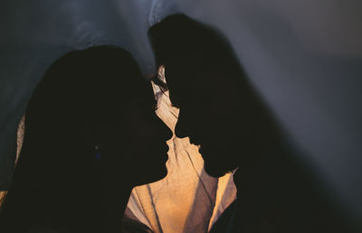 Shadow of people holding cross