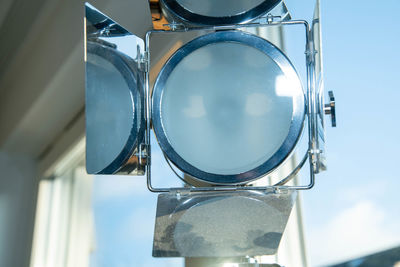 Low angle view of electric lamp against sky