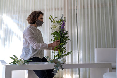 Woman holding flowers at home