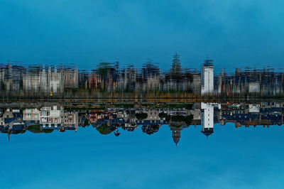 Reflection of buildings in calm lake