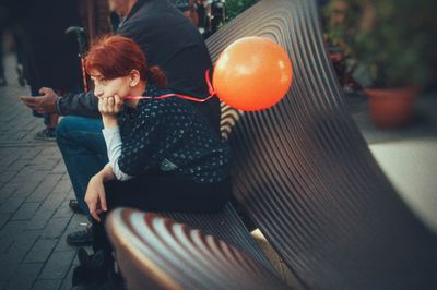 Rear view of people sitting outdoors