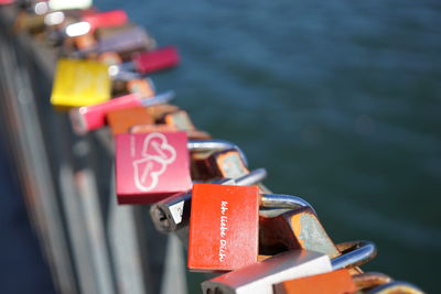 Close-up of love locks on bridge over river