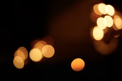 Defocused image of illuminated christmas lights at night