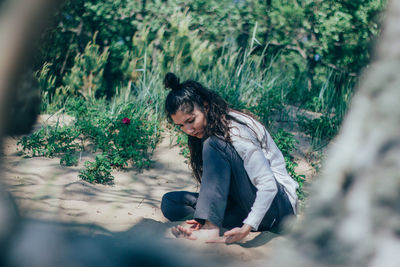 Young woman sitting in park