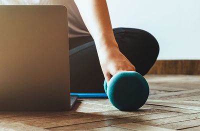 Low section of woman sitting on table at home
