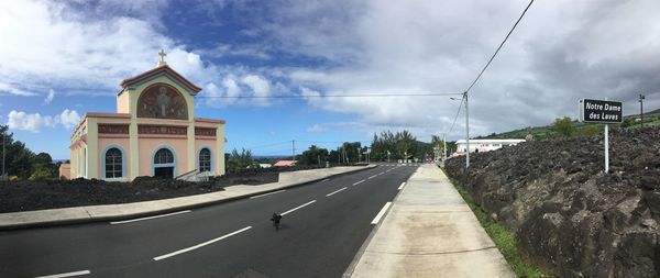 Road amidst buildings against sky in city