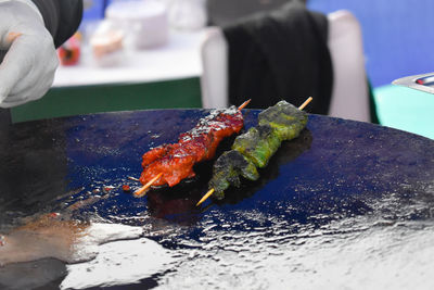 Close-up of person preparing food on table