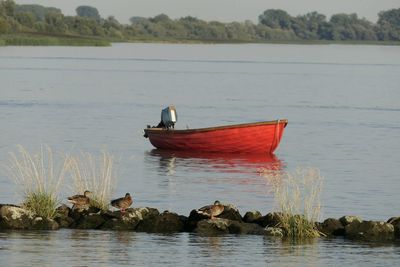 Boat in lake against sky