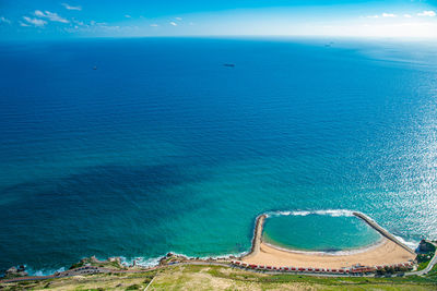 High angle view of sea against blue sky