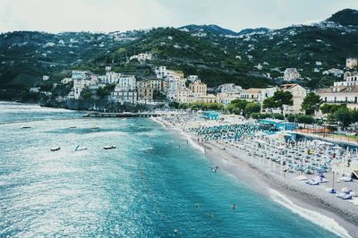 Buildings by sea against sky in city