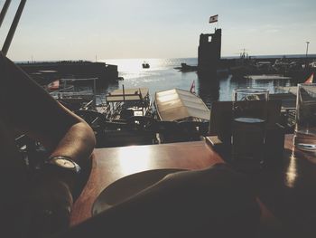 Man in boat against sky in city