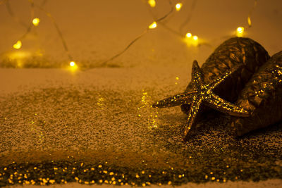 Close-up of illuminated lighting equipment on beach