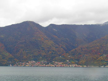 Scenic view of sea and mountains against sky