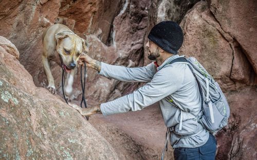 Hiker with dog on rocks