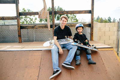 Skateboard instructor and student smile for a portrait