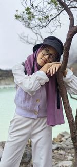 Portrait of young woman standing on beach