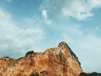 Low angle view of rocky mountain against sky