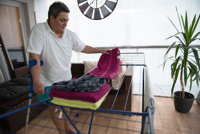 A disabled person washes laundry.
