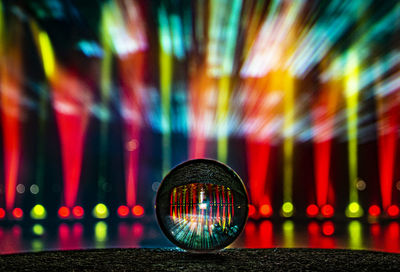 Close-up of illuminated lighting equipment on railing