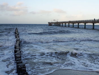 Pier over sea against sky