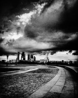 View of cityscape against cloudy sky