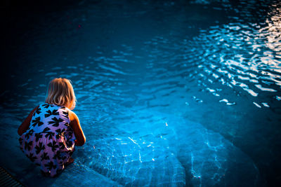 Rear view of woman swimming in sea