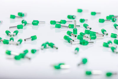 Close-up of colored pencils over white background