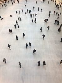 High angle view of people walking on tiled floor