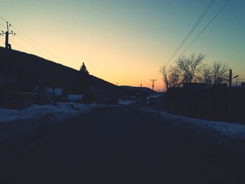 Snow covered landscape at sunset