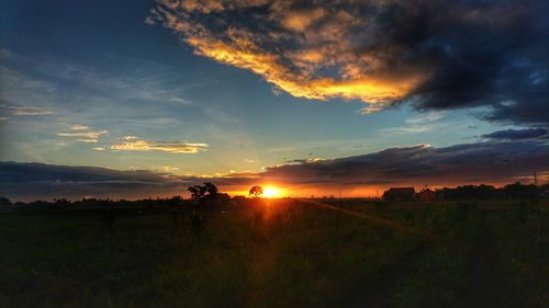 Scenic view of field against sky during sunset