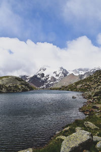 Scenic view of lake and mountains against sky