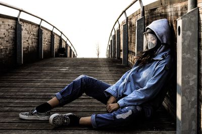 Woman lying on sidewalk in city