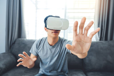 Man wearing virtual reality while sitting at home