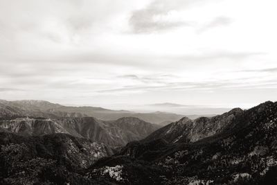 Scenic view of mountains against cloudy sky